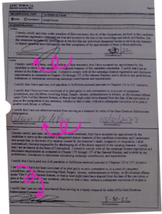 A small white dog sitting on top of a bed.